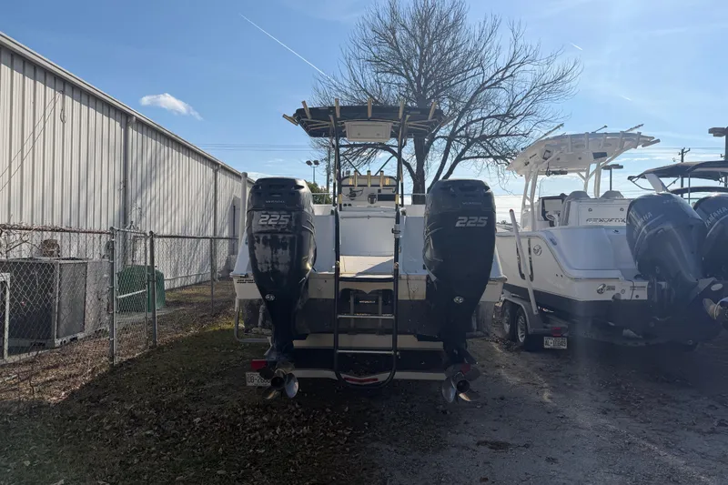 Slide: The Image of 2002 Pro Sports 2860 CC ProKat boat with dual Yamaha 225 engines, parked outdoors. - 1