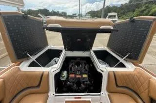 Slide: The Image of 2017 Tigé RZX2 boat engine compartment with open storage hatches. - 27