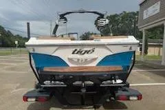 Slide: The Image of 2017 Tigé RZX2 boat, rear view, parked outdoors on a sunny day. - 3