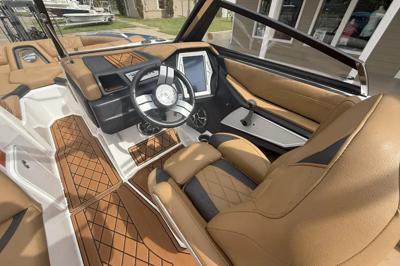 Slide: The Image of 2017 Tigé RZX2 boat interior with tan leather seats and modern dashboard. - 37