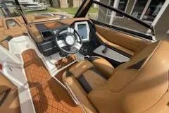 Slide: The Image of 2017 Tigé RZX2 boat interior with tan leather seats and modern dashboard. - 9