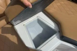 Slide: The Image of 2017 Tigé RZX2 boat storage compartment with tan upholstery and diamond stitching. - 15