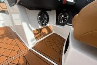 Slide: The Image of 2017 Tigé RZX2 boat interior with brown flooring and speaker system. - 19