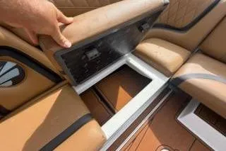 Slide: The Image of 2017 Tigé RZX2 boat interior storage compartment with tan leather seating. - 21