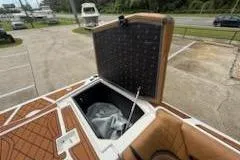 Slide: The Image of 2017 Tigé RZX2 boat storage compartment open, showcasing interior space and design. - 25