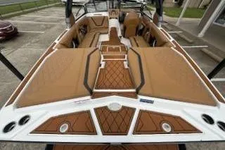 Slide: The Image of 2017 Tigé RZX2 boat interior with brown cushioned seating and stylish deck design. - 31