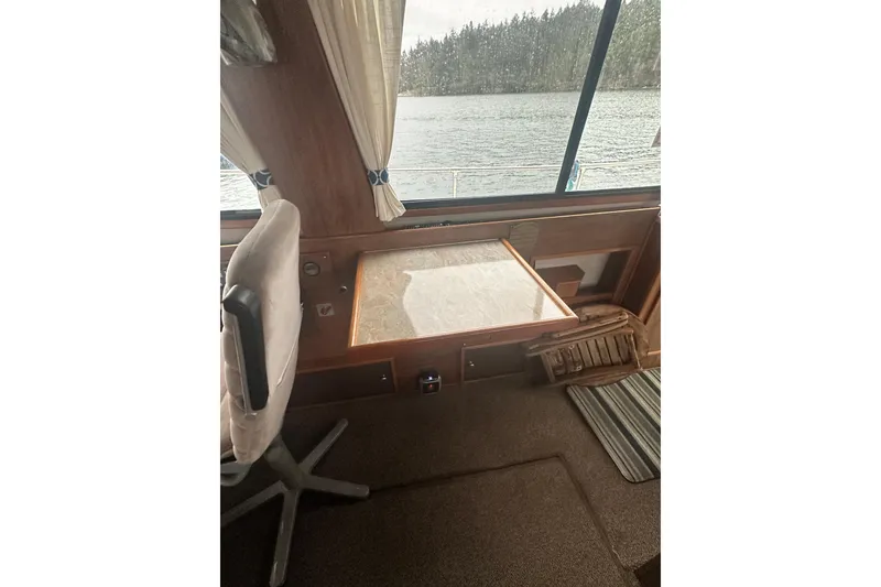 Slide: The Image of Interior of 1982 Campion 310 boat with table and chair by window. - 10