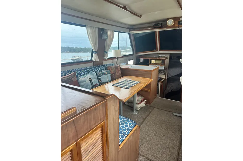Slide: The Image of Interior of 1982 Campion 310 boat with cozy seating and wooden table. - 13