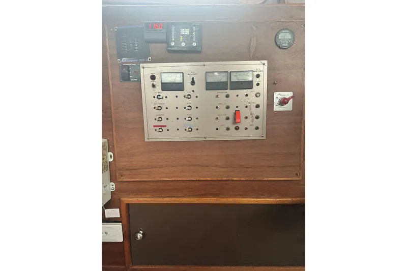 Slide: The Image of Control panel of a 1982 Campion 310 boat, featuring gauges and switches. - 15