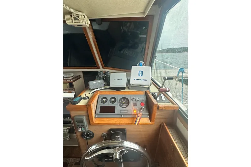 Slide: The Image of Interior of a 1982 Campion 310 boat cockpit with navigation equipment. - 17