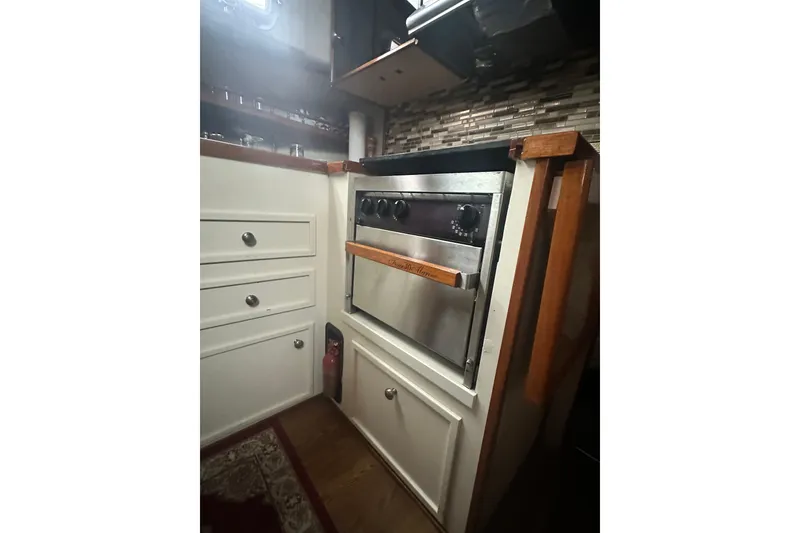 Slide: The Image of 1982 Campion 310 boat kitchen with stove and cabinets. - 21