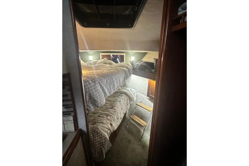 Slide: The Image of Interior of 1982 Campion 310 boat with cozy bunk beds and wooden ladder. - 30