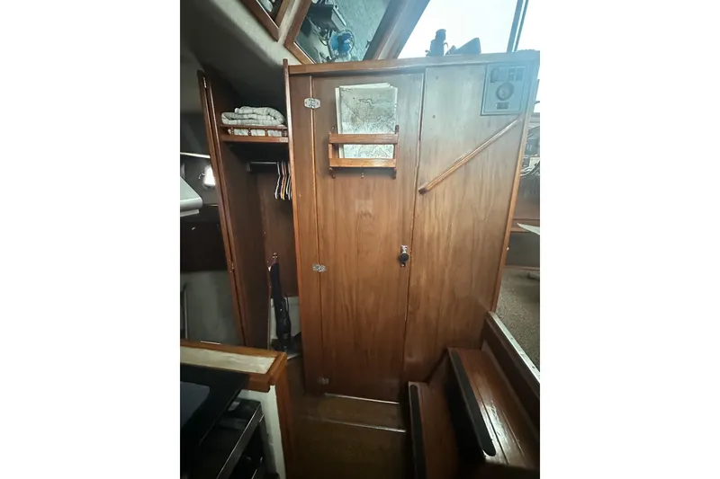 Slide: The Image of Interior of 1982 Campion 310 boat with wooden cabinetry and storage space. - 33