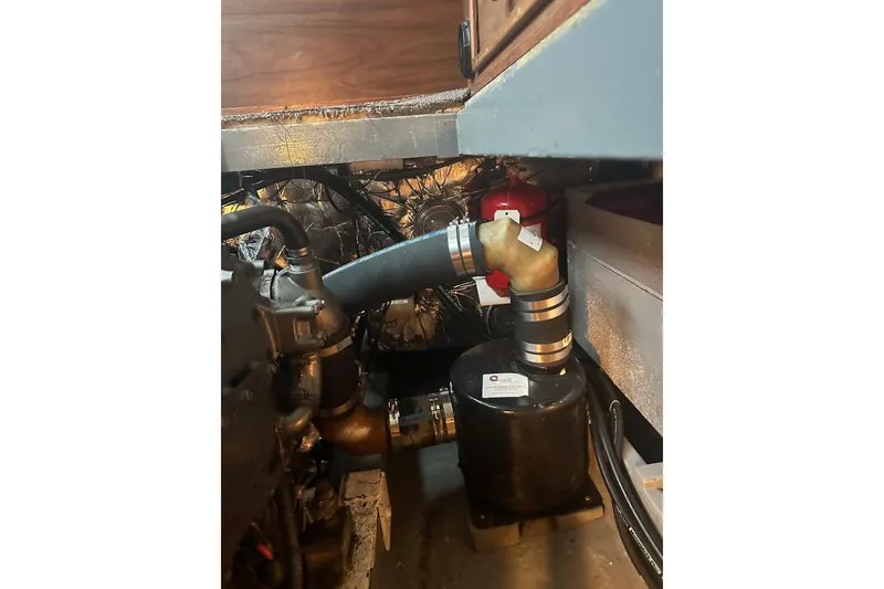 Slide: The Image of Engine compartment of a 1982 Campion 310 boat, showing hoses and components. - 40