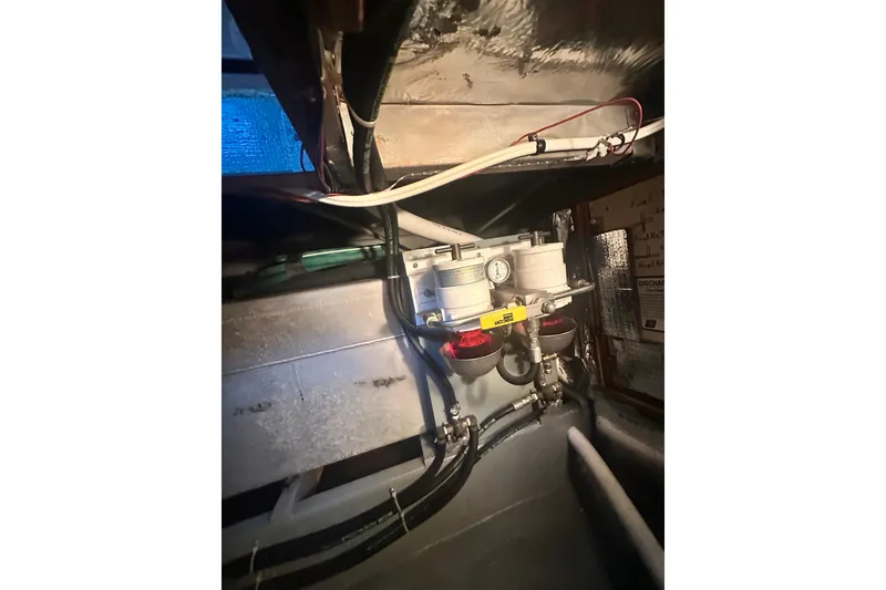 Slide: The Image of Engine compartment of a 1982 Campion 310 boat, showing fuel system components. - 46