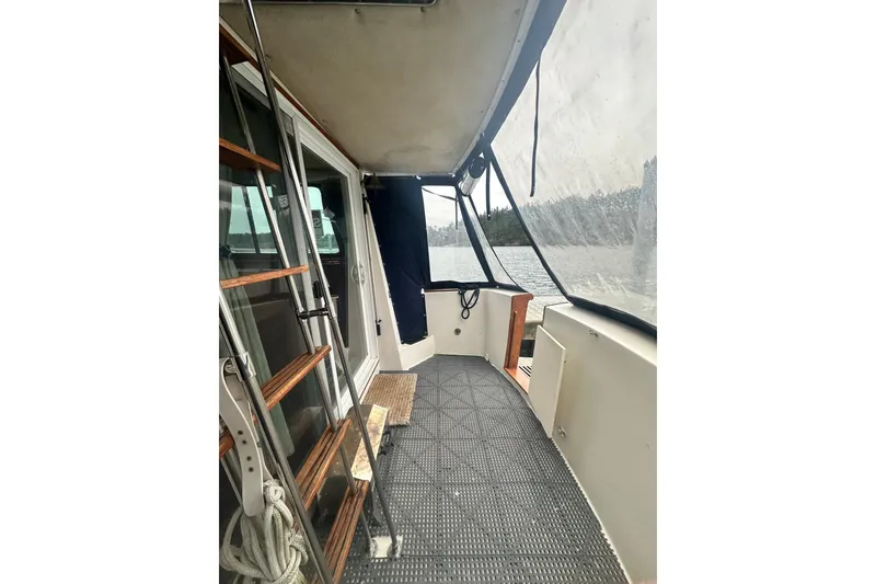 Slide: The Image of 1982 Campion 310 boat interior with ladder, window, and lake view. - 6