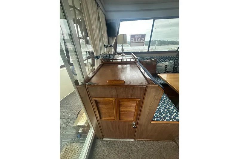 Slide: The Image of Interior of 1982 Campion 310 boat with wooden cabinetry and blue patterned seating. - 7