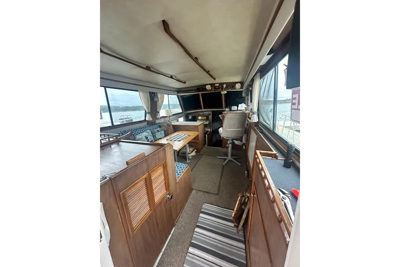 Slide: The Image of Interior of a 1982 Campion 310 boat with wooden furnishings and seating area. - 9