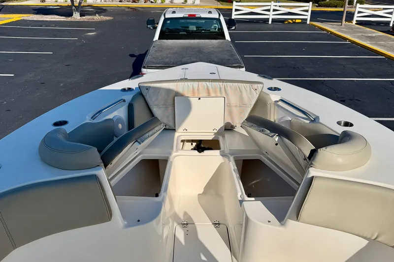 Slide: The Image of 2023 Key West 263 FS boat interior with seating and storage, parked in a lot. - 10