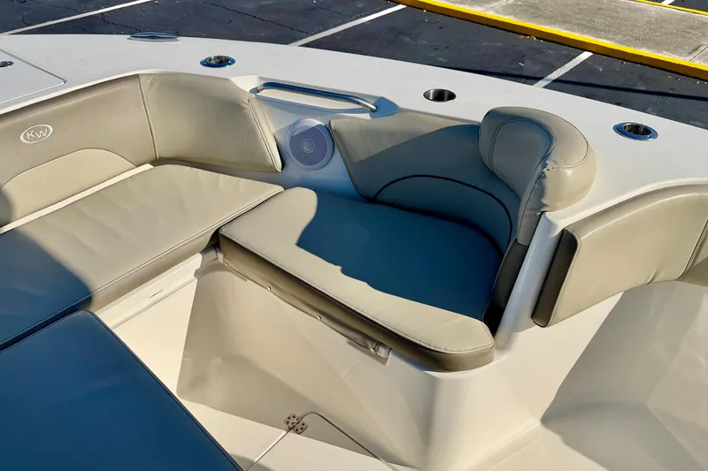 Slide: The Image of 2023 Key West 263 FS boat interior seating with cup holders and speaker. - 13