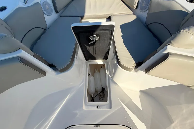 Slide: The Image of 2023 Key West 263 FS boat interior with cushioned seating and storage compartment. - 19