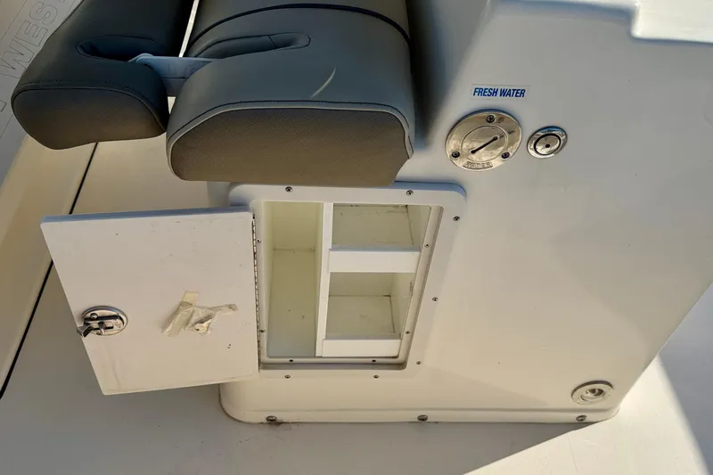 Slide: The Image of 2023 Key West 263 FS boat storage compartment with open door and fresh water access. - 38