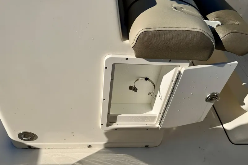 Slide: The Image of Open storage compartment on 2023 Key West 263 FS boat, featuring a cushioned seat. - 39