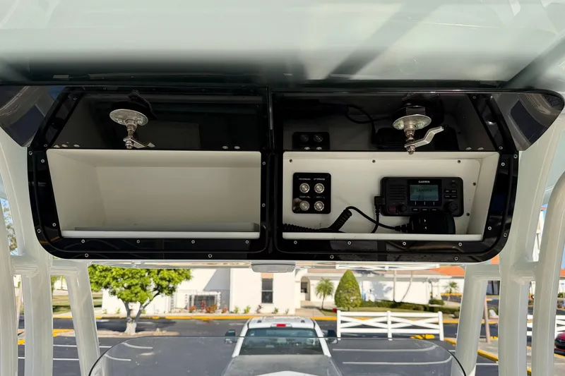 Slide: The Image of 2023 Key West 263 FS boat console with storage compartments and electronic controls. - 41