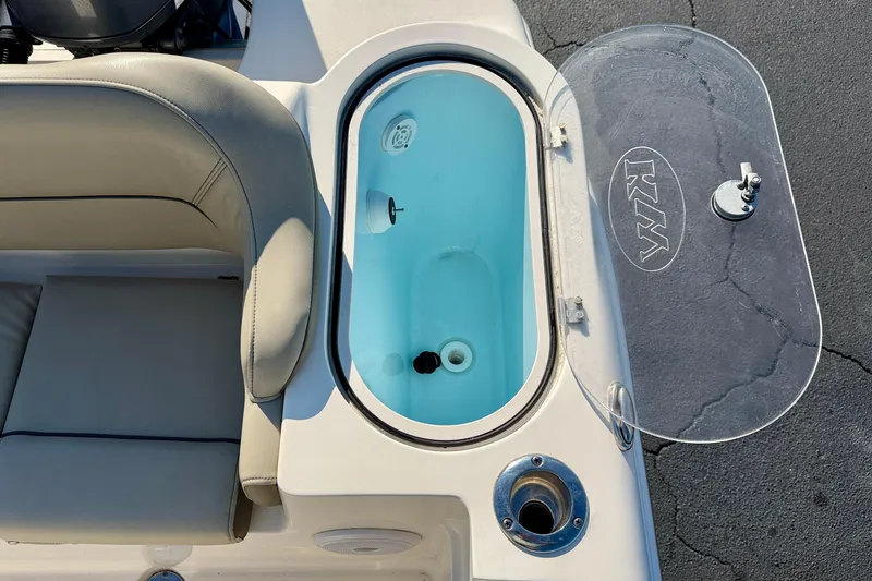 Slide: The Image of 2023 Key West 263 FS boat livewell with cushioned seating and transparent lid. - 49