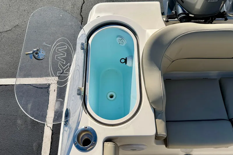 Slide: The Image of 2023 Key West 263 FS boat livewell with transparent lid and seating area. - 50