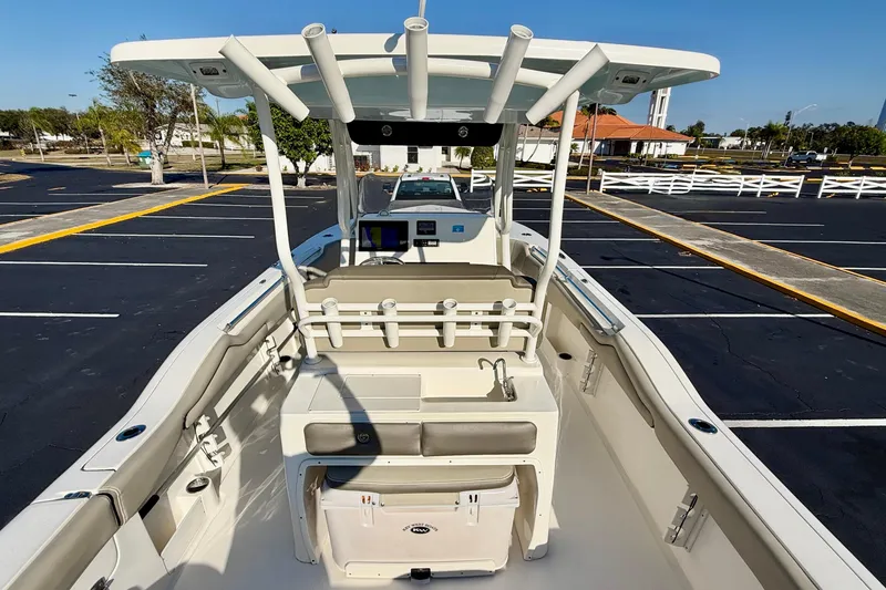 Slide: The Image of 2023 Key West 263 FS boat interior with seating and console in parking lot. - 54