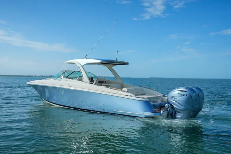 Slide: The Image of 2019 Chris-Craft Launch 35 GT OB boat on calm blue water. - 10