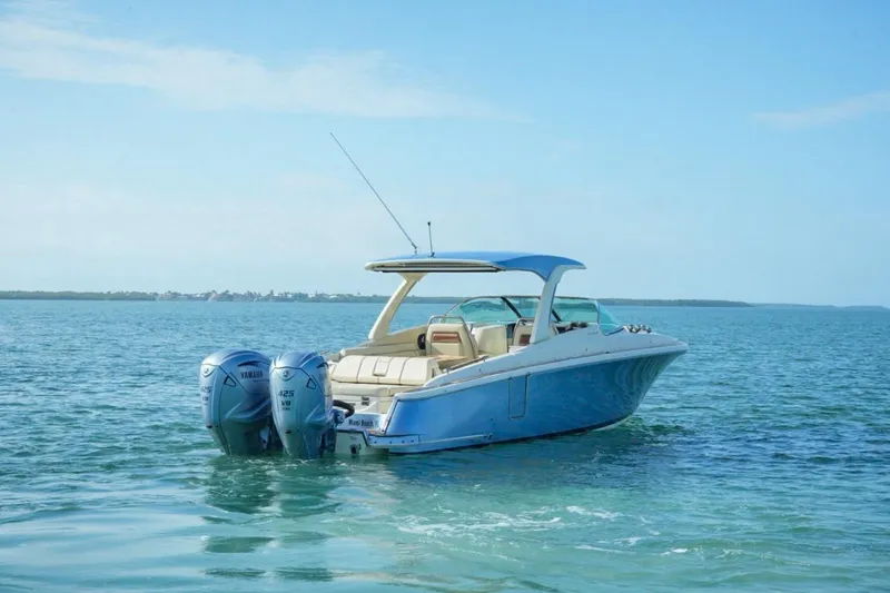 Slide: The Image of 2019 Chris-Craft Launch 35 GT OB boat on calm blue water. - 14
