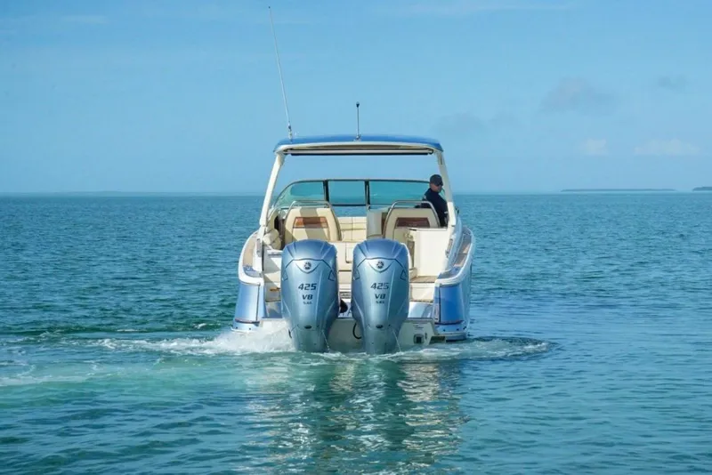 Slide: The Image of 2019 Chris-Craft Launch 35 GT OB cruising on open water, rear view. - 2
