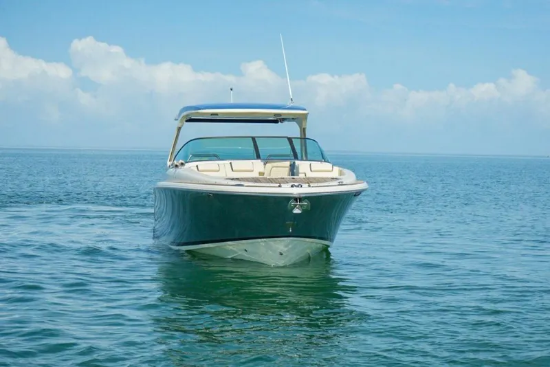 Slide: The Image of 2019 Chris-Craft Launch 35 GT OB boat on calm blue water under clear sky. - 22
