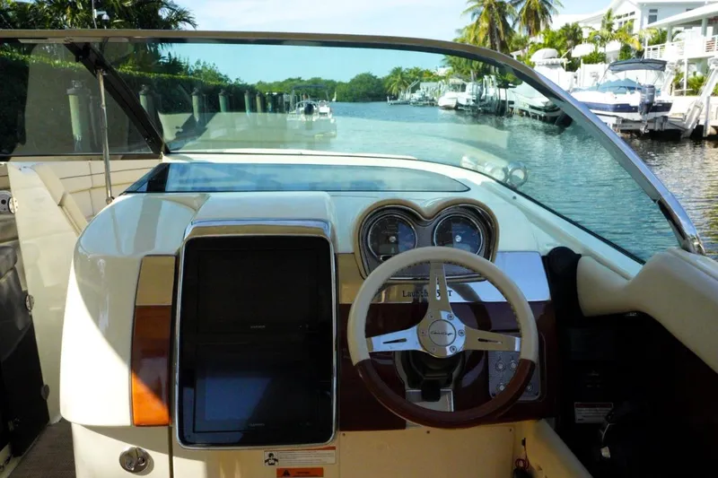 Slide: The Image of 2019 Chris-Craft Launch 35 GT OB dashboard with steering wheel and gauges. - 35
