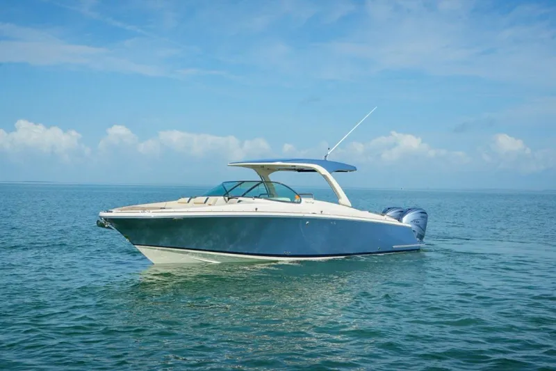 Slide: The Image of 2019 Chris-Craft Launch 35 GT OB boat on calm ocean waters under blue sky. - 5