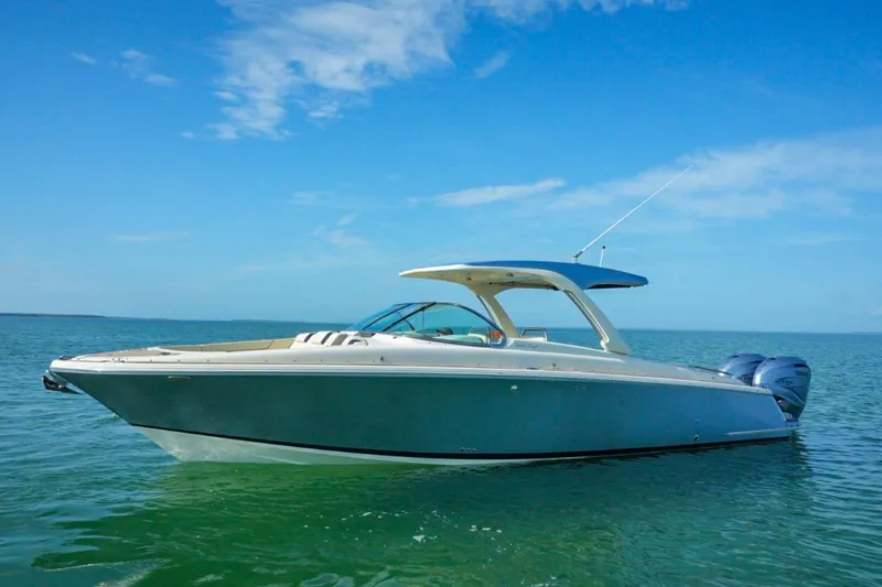 Slide: The Image of 2019 Chris-Craft Launch 35 GT OB boat on calm water under blue sky. - 8