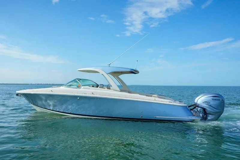 Slide: The Image of 2019 Chris-Craft Launch 35 GT OB boat on calm water, featuring Yamaha outboard engines. - 9
