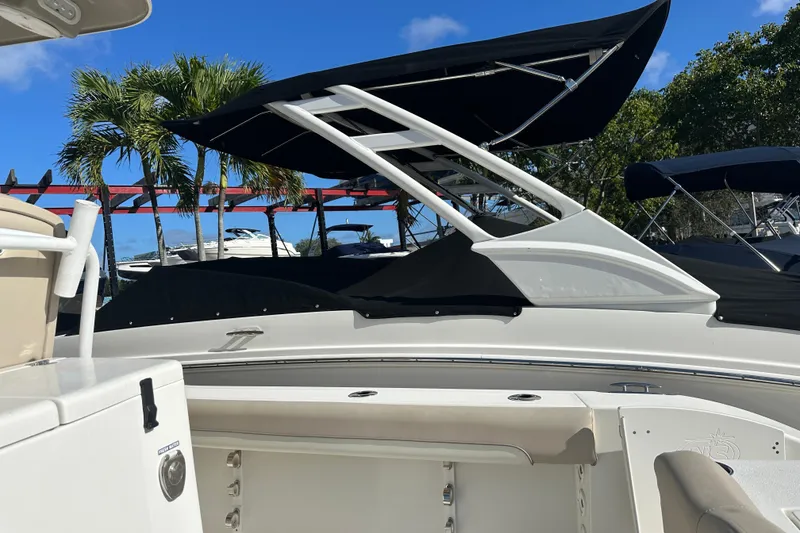 Slide: The Image of 2017 NauticStar 28 XS boat with canopy, docked under clear blue sky. - 2