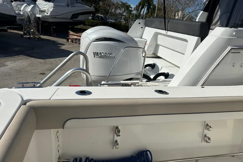 Slide: The Image of 2017 NauticStar 28 XS boat with Yamaha engine, docked outdoors. - 3
