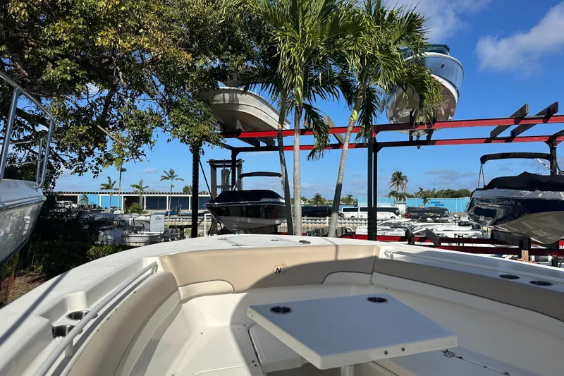 Slide: The Image of 2017 NauticStar 28 XS boat in marina with palm trees and blue sky. - 4