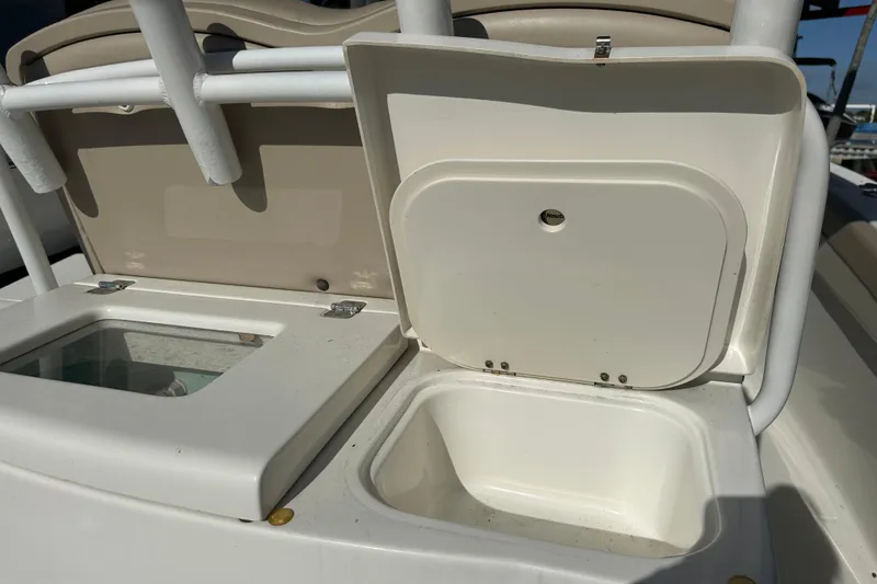 Slide: The Image of 2017 NauticStar 28 XS boat storage compartments with open lids. - 8
