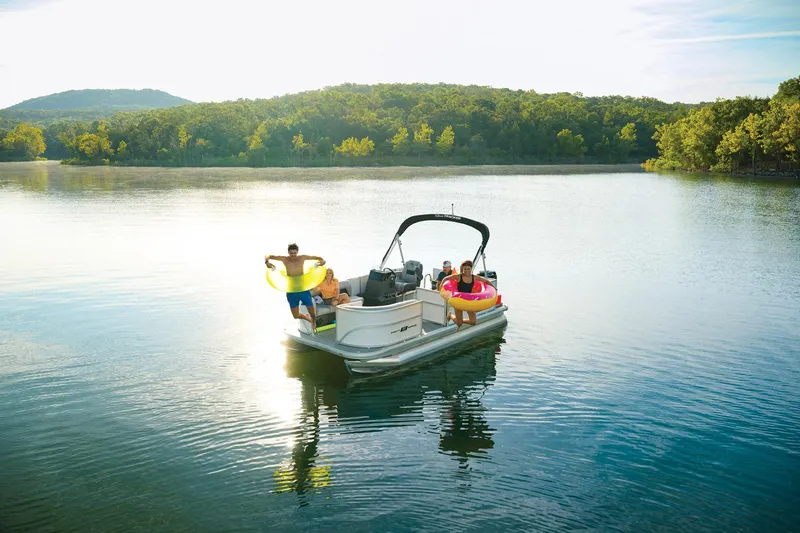 Slide: The Image of 2026 Sun Tracker Party Barge 16 DLX steering console with modern controls and cup holder. - 5