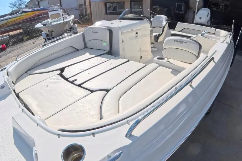Slide: The Image of 2020 Stingray 212 SC boat interior with steering wheel and seating area. - 13