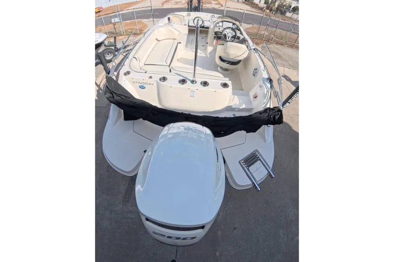 Slide: The Image of Trailer hitch mechanism for 2020 Stingray 212 SC boat on gravel surface. - 16