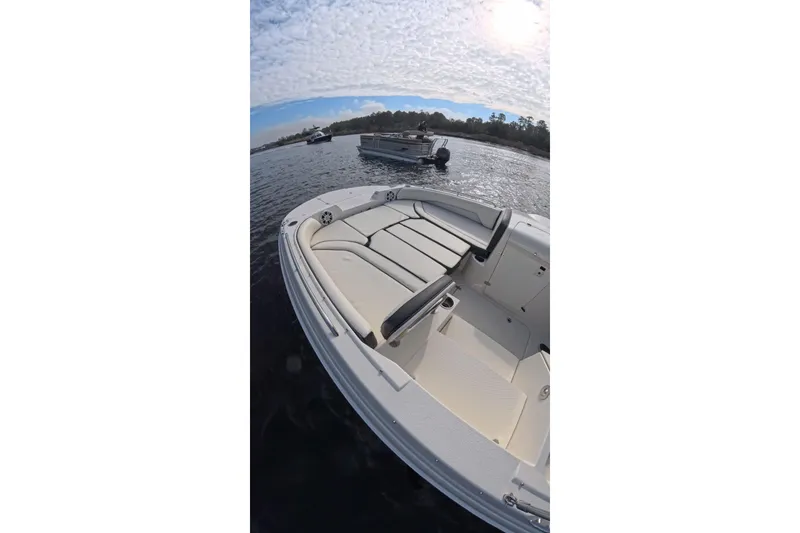 Slide: The Image of 2020 Stingray 212 SC boat on a calm river under cloudy skies. - 6