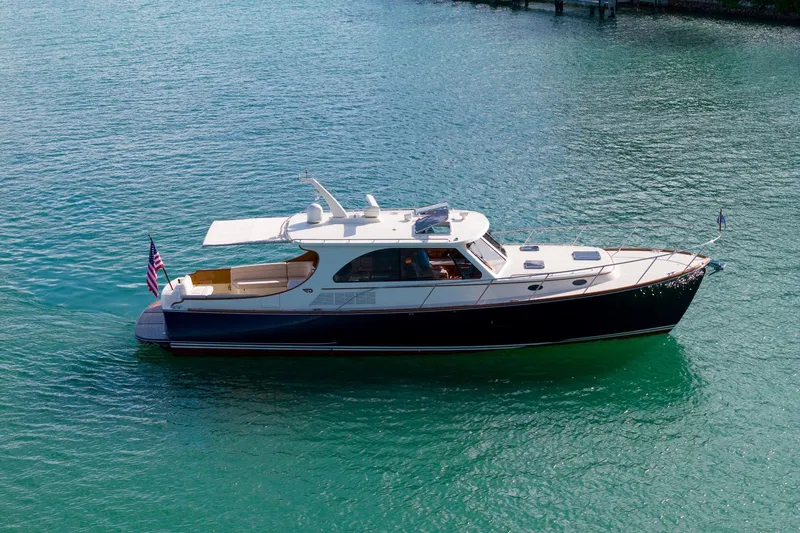 Slide: The Image of 2015 Hinckley Talaria 43 Motoryacht cruising on clear blue water. - 17