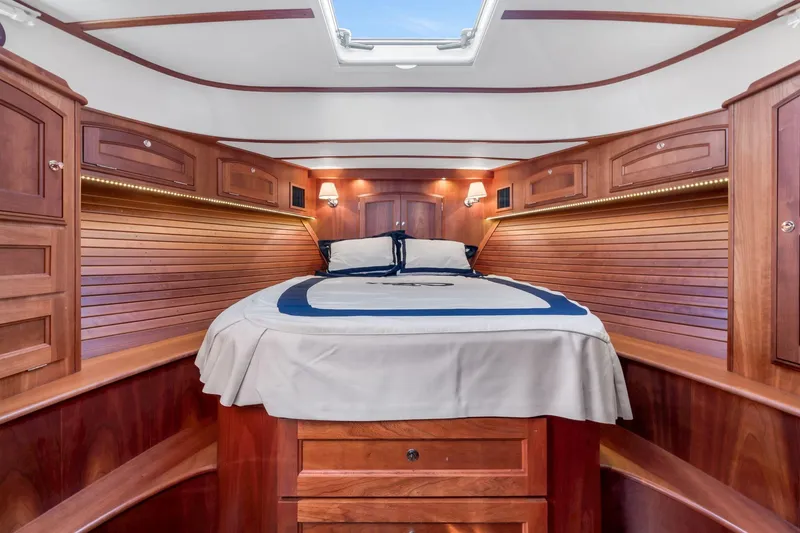 Slide: The Image of Luxurious 2015 Hinckley Talaria 43 Motoryacht cabin with elegant wood finish and cozy bedding. - 9