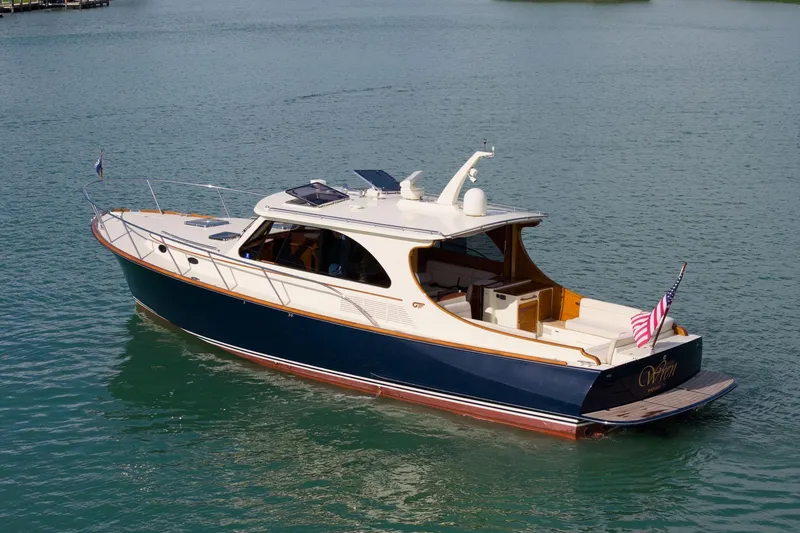 Slide: The Image of 2015 Hinckley Talaria 43 Motoryacht cruising on clear blue water. - 18